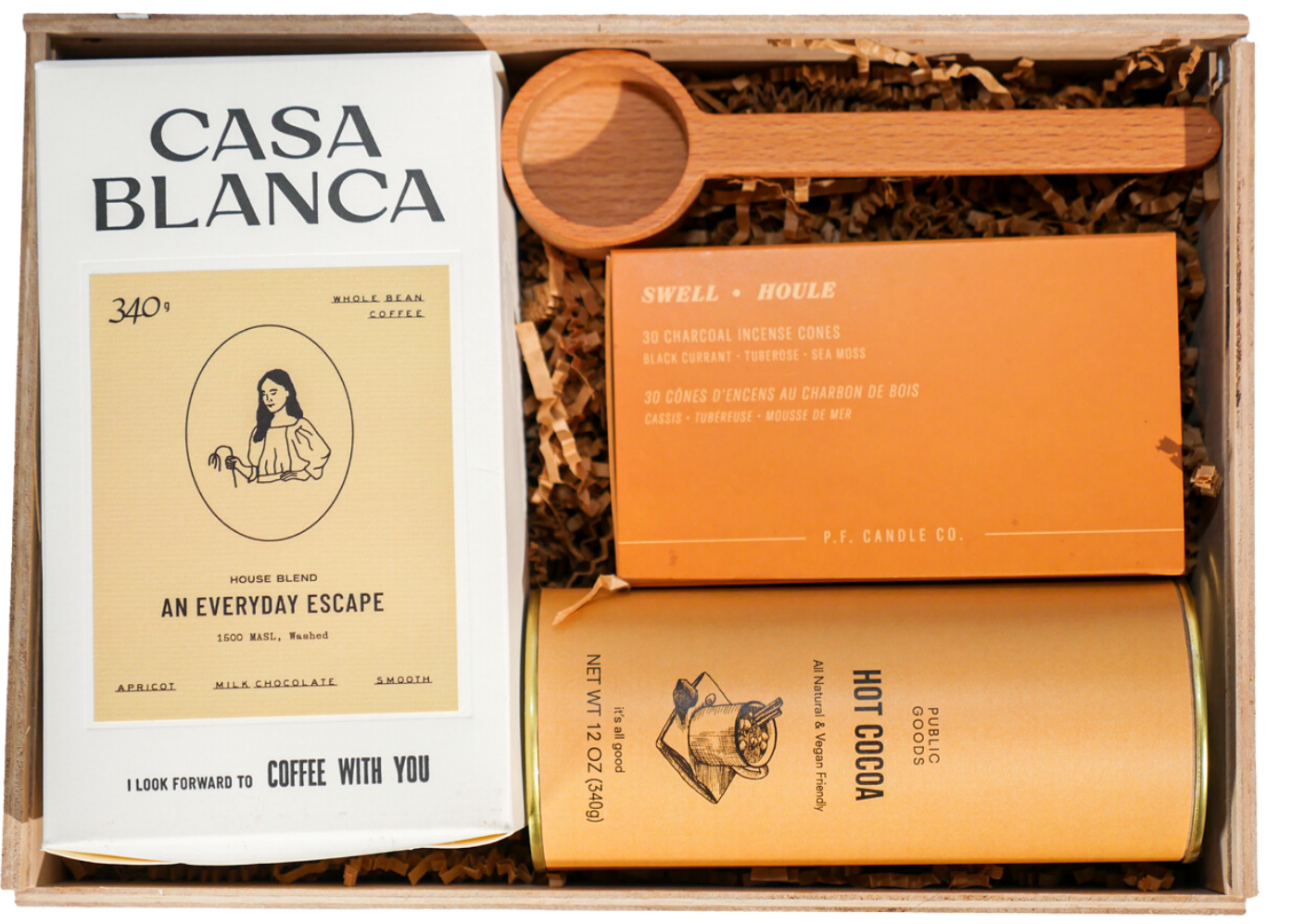 A custom wooden gift box with Casa Blanca coffee, hot cocoa, P.F. Candle Co. incense and a wooden scoop